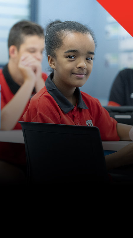 Student smiling in the classroom at Xavier College Llandilo