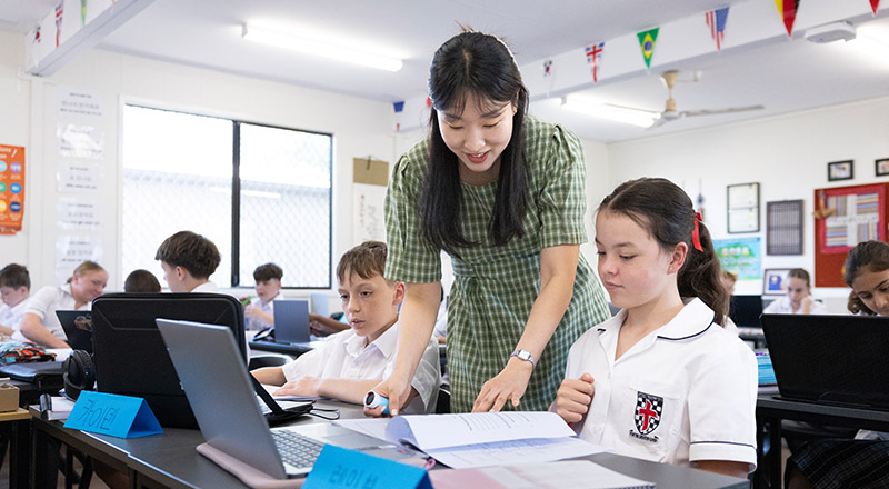 Teacher working with her student in the classroom at Xavier College Llandilo