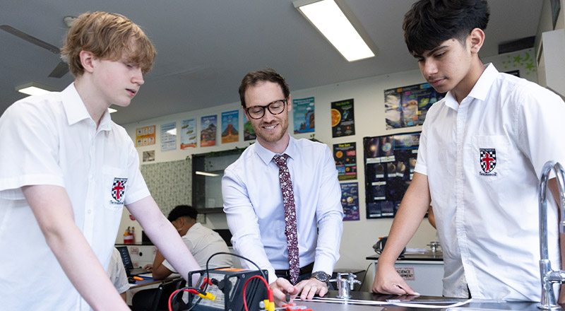 Teacher working with his students in the science lab at Xavier College Llandilo