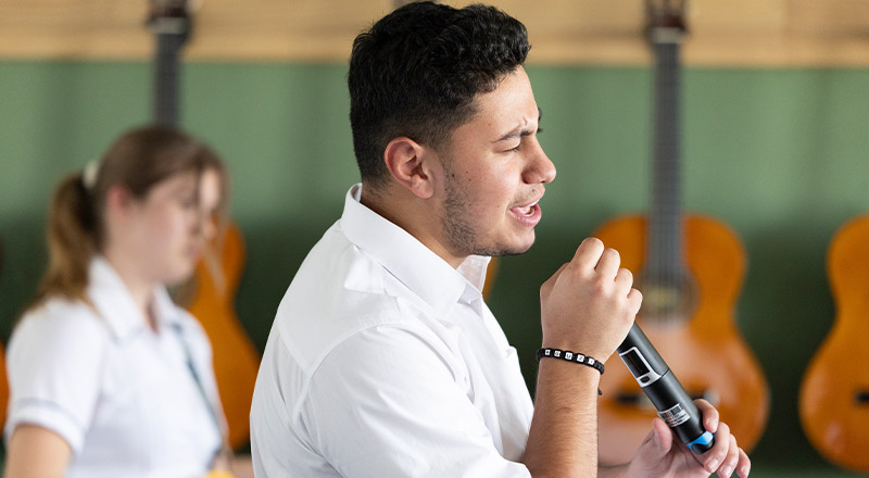 Student singing in the performing arts room at Xavier College Llandilo
