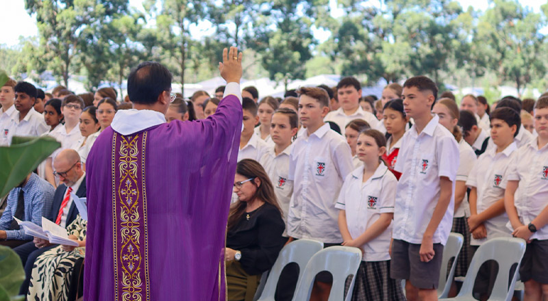 Students attending a liturgy outside at Xavier College Llandilo