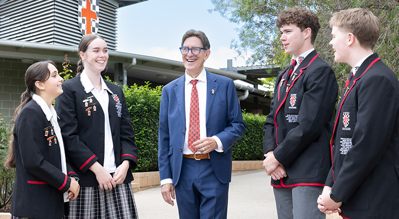 Students with the school principal Michael Pate in the school grounds at Xavier College Llandilo