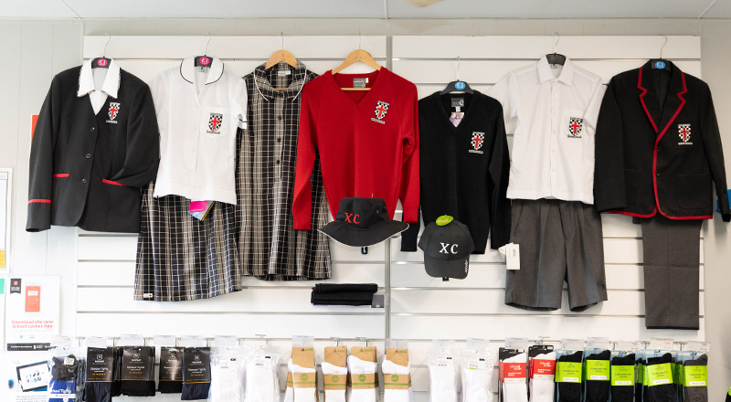 The school uniform hanging in the uniform shop at Xavier College Llandilo
