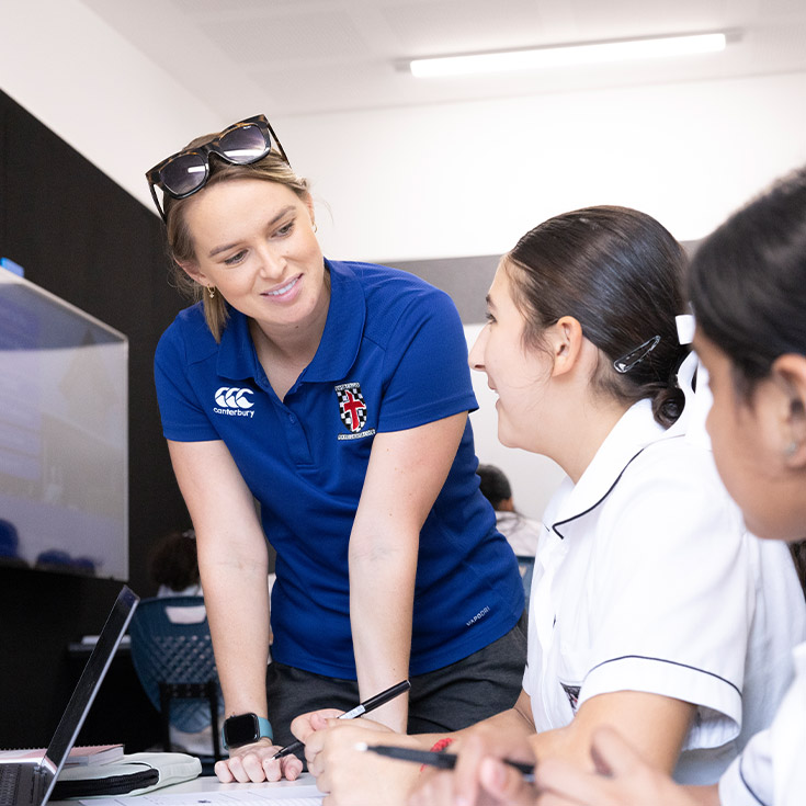 Teacher wither her students in the classroom at Xavier College Llandilo