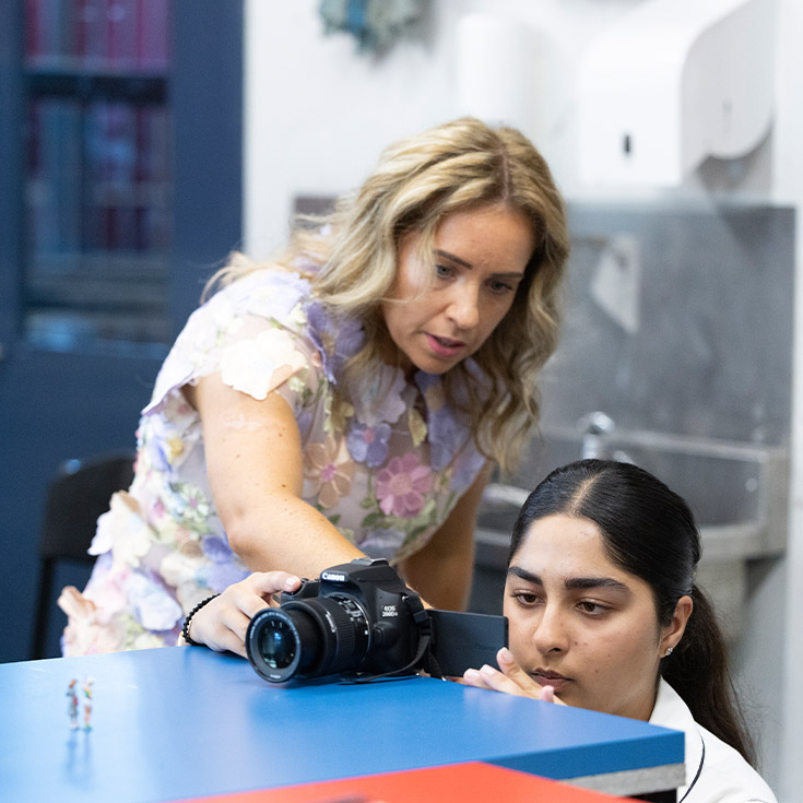 Teacher helping her student take photos in class at Xavier College Llandilo