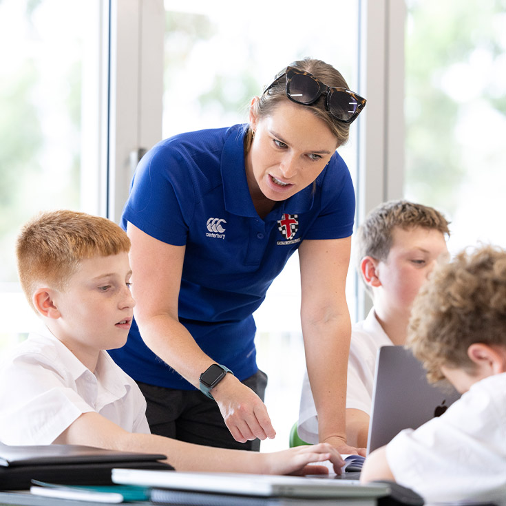 Teacher working with her students in the classroom at Xavier College Llandilo