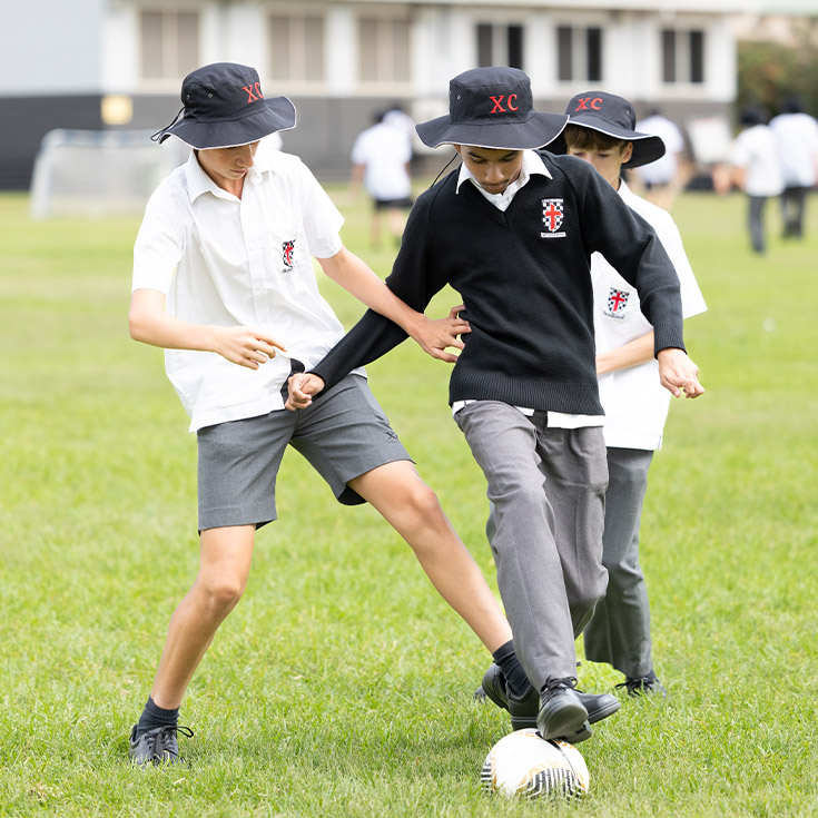Students playing soccer on the school oval at Xavier College Llandilo
