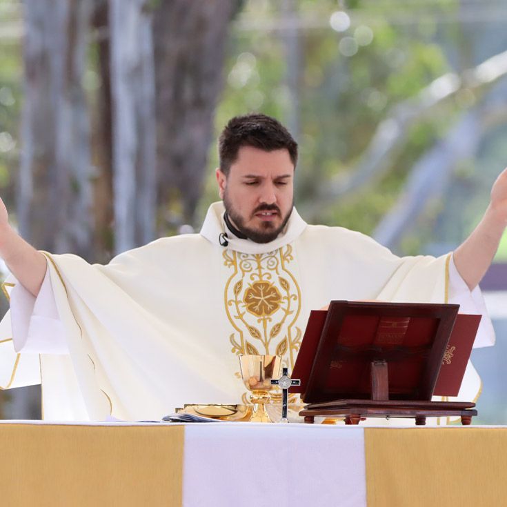Priest leading school in prayer at Xavier College Llandilo
