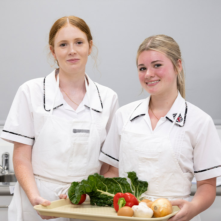 Students learning in the hospitality kitchen at Xavier College Llandilo