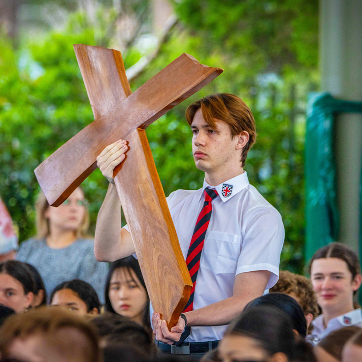 Student participating in a school mass at Xavier College Llandilo