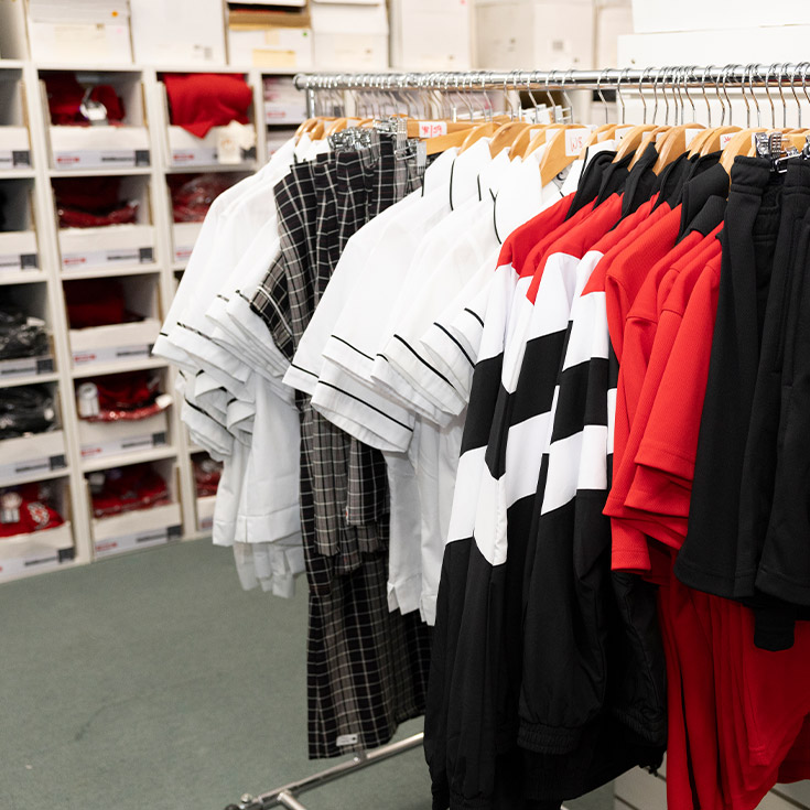 The school uniform hanging in the uniform shop at Xavier College Llandilo
