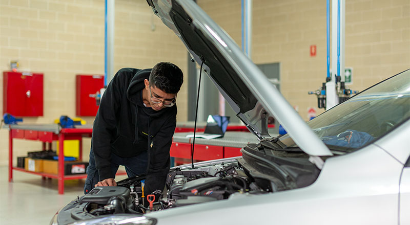 CathWest student working on a car