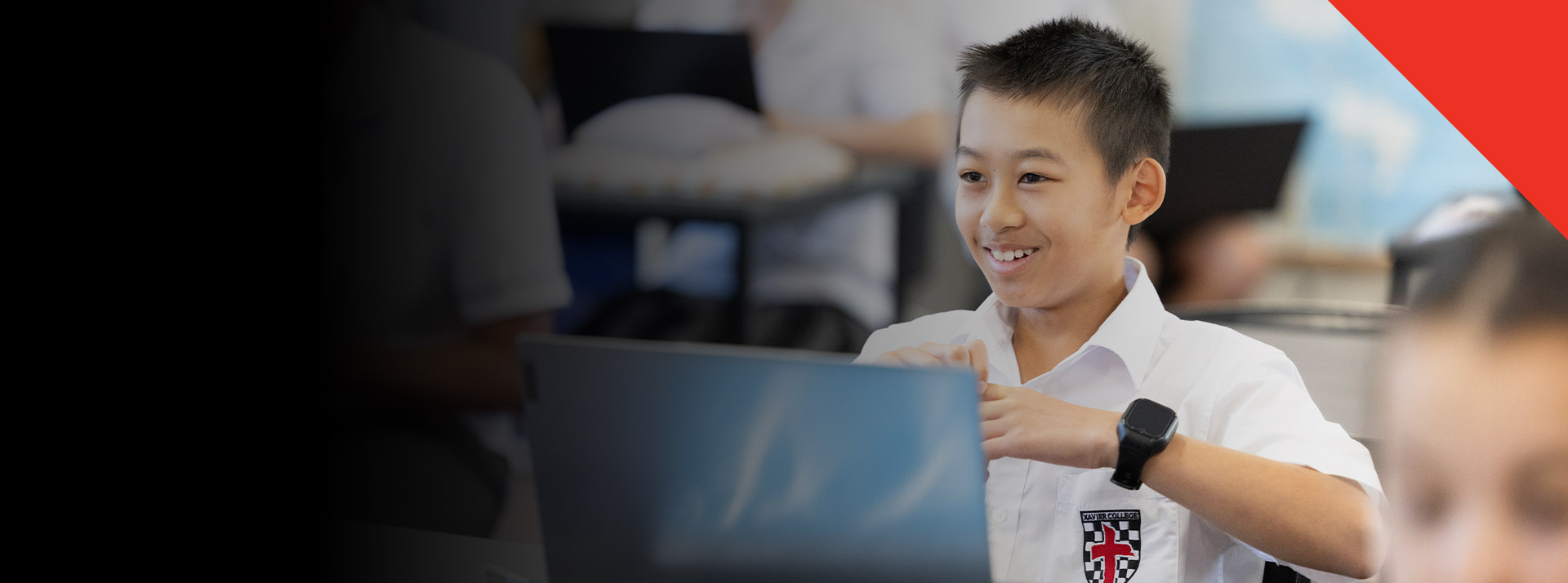 Student smiling in the classroom at Xavier College Llandilo