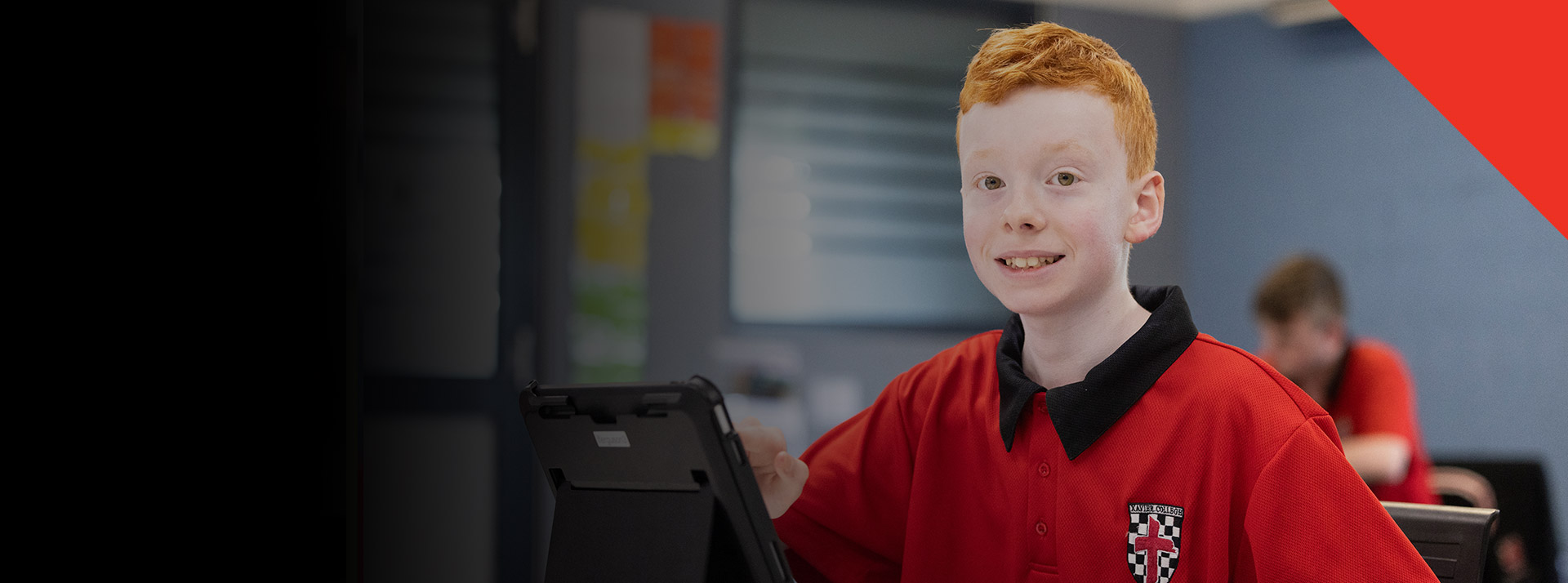 Student smiling in the classroom at Xavier College Llandilo