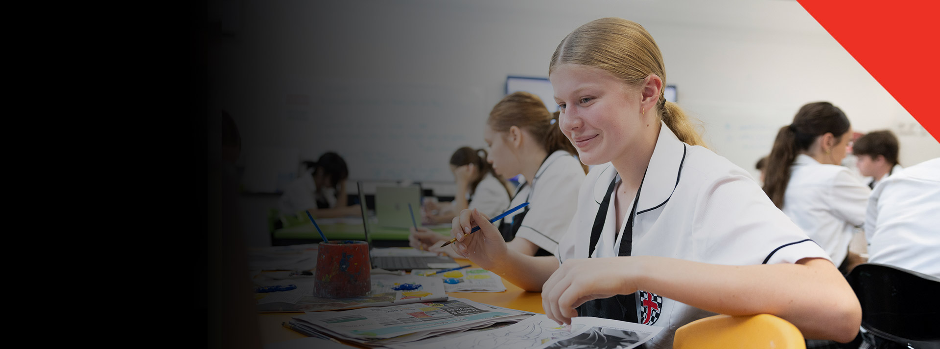 Student painting in the classroom at Xavier College Llandilo