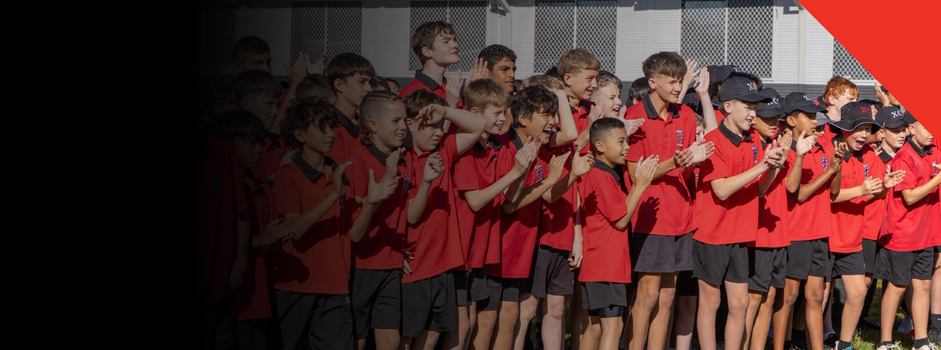 Students cheering on their classmates during a school event at Xavier College Llandilo