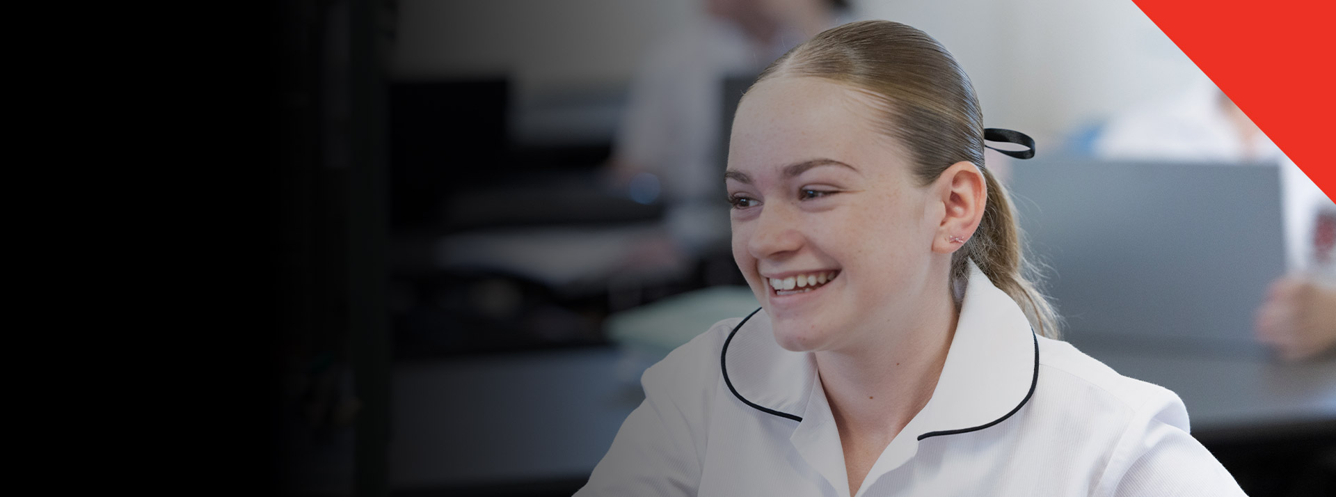 Student smiling in the classroom at Xavier College Llandilo