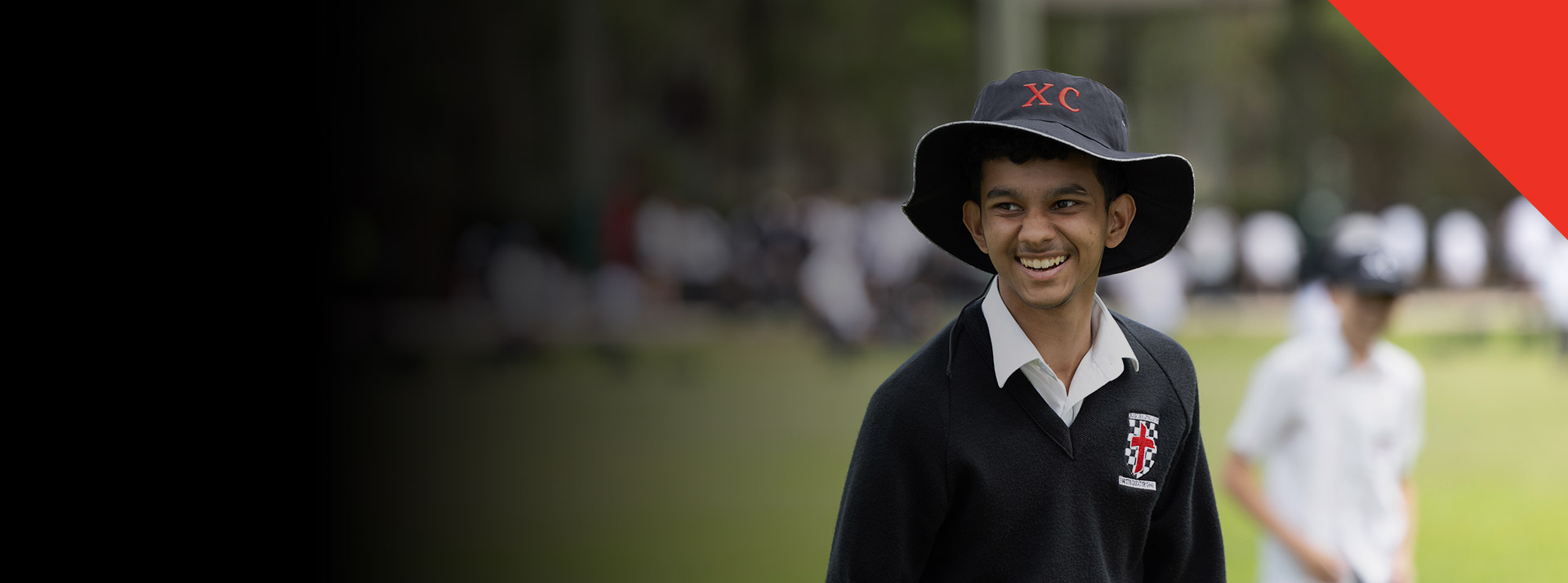 Student smiling on the school oval at Xavier College Llandilo