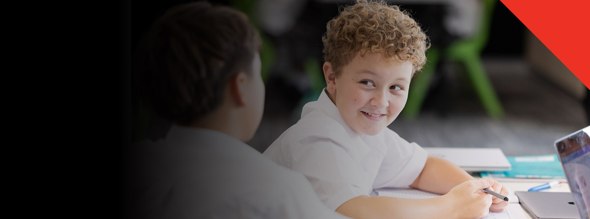 Student smiling in the classroom at Xavier College Llandilo