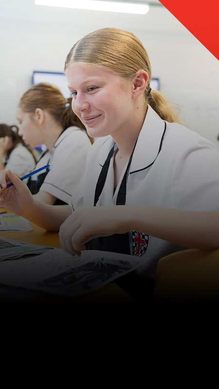 Student painting in the classroom at Xavier College Llandilo