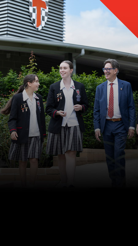 Students walking with their principal Michael Pate through the school grounds at Xavier College Llandilo