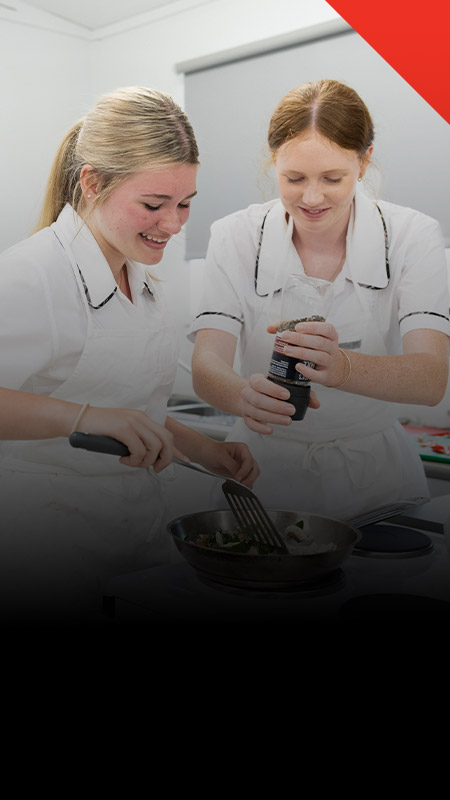 Students cooking together in the commercial kitchen at Xavier College Llandilo