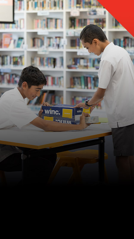 Students working on a project in the library at Xavier College Llandilo