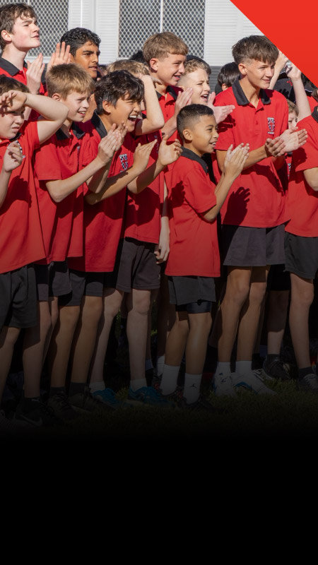 Students cheering on their classmates during a school event at Xavier College Llandilo