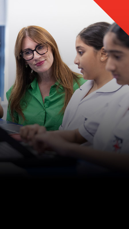 Teacher working with her students in the classroom at Xavier College Llandilo