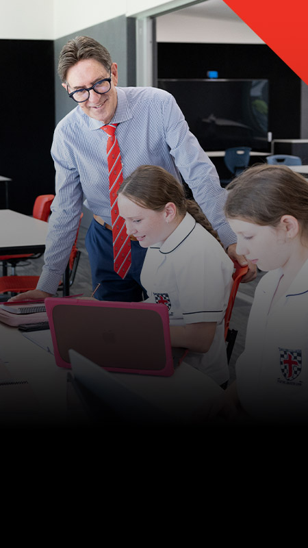 Principal of Xavier College Llandilo, Michael Pate with student sin the classroom