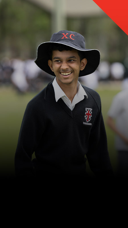 Student smiling on the school oval at Xavier College Llandilo
