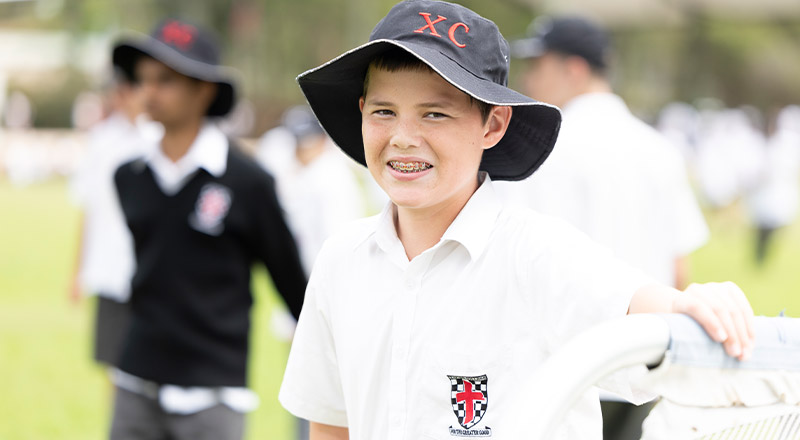 Student smiling in the playground at Xavier College Llandilo